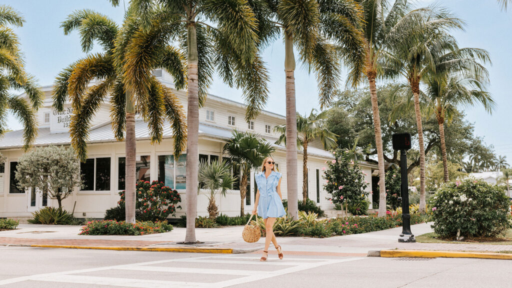 A woman strolls through the Old Naples neighborhood in Naples, Florida.