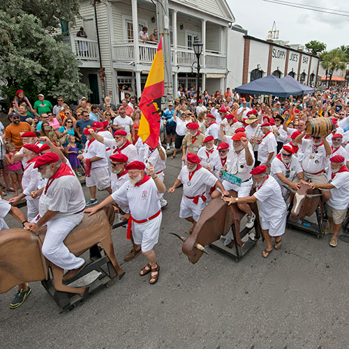 A horde of Hemingway lookalikes reenact the running of the bulls in Key West, Florida,