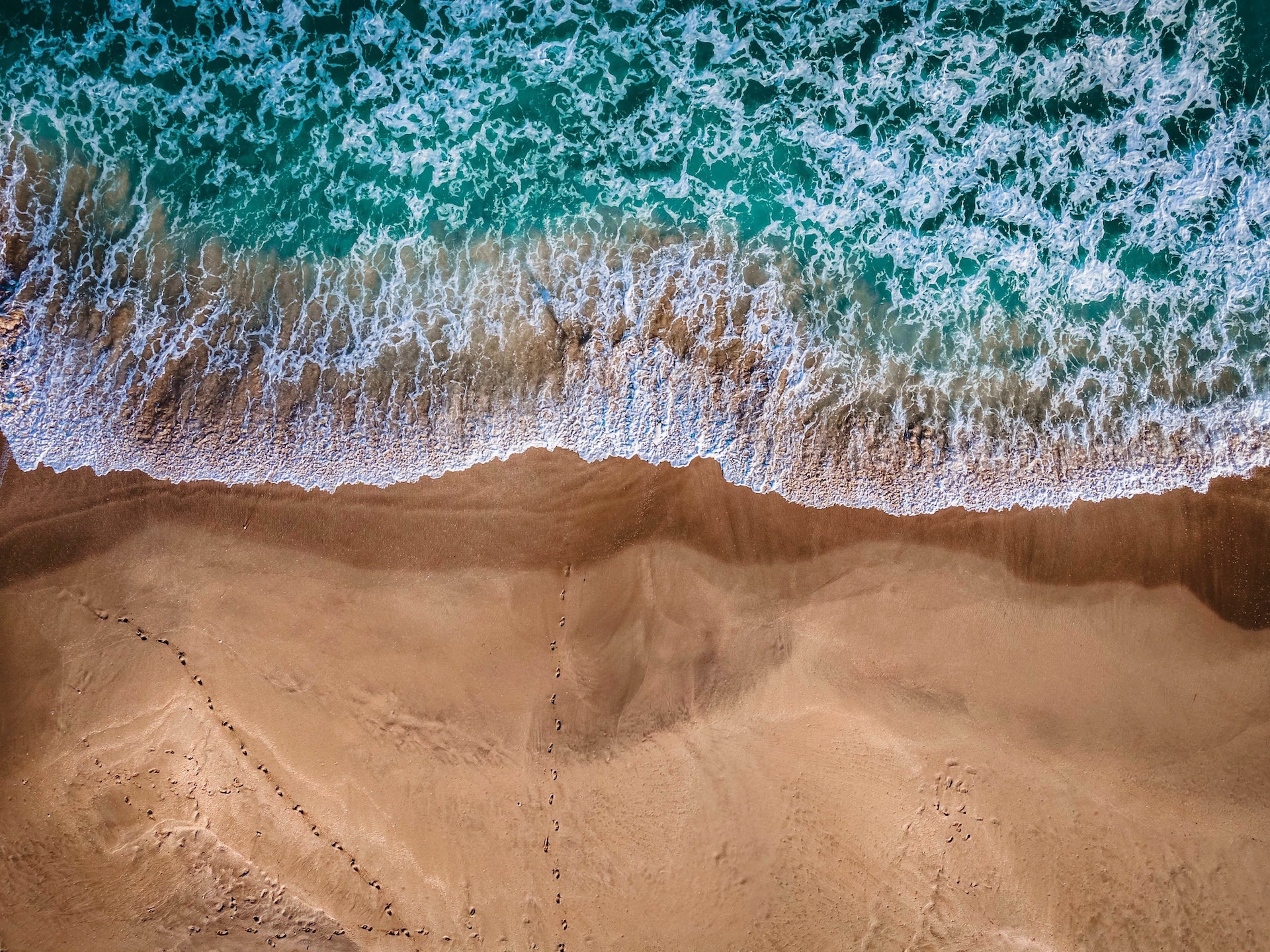 overhead shot of waves on jupiter beach