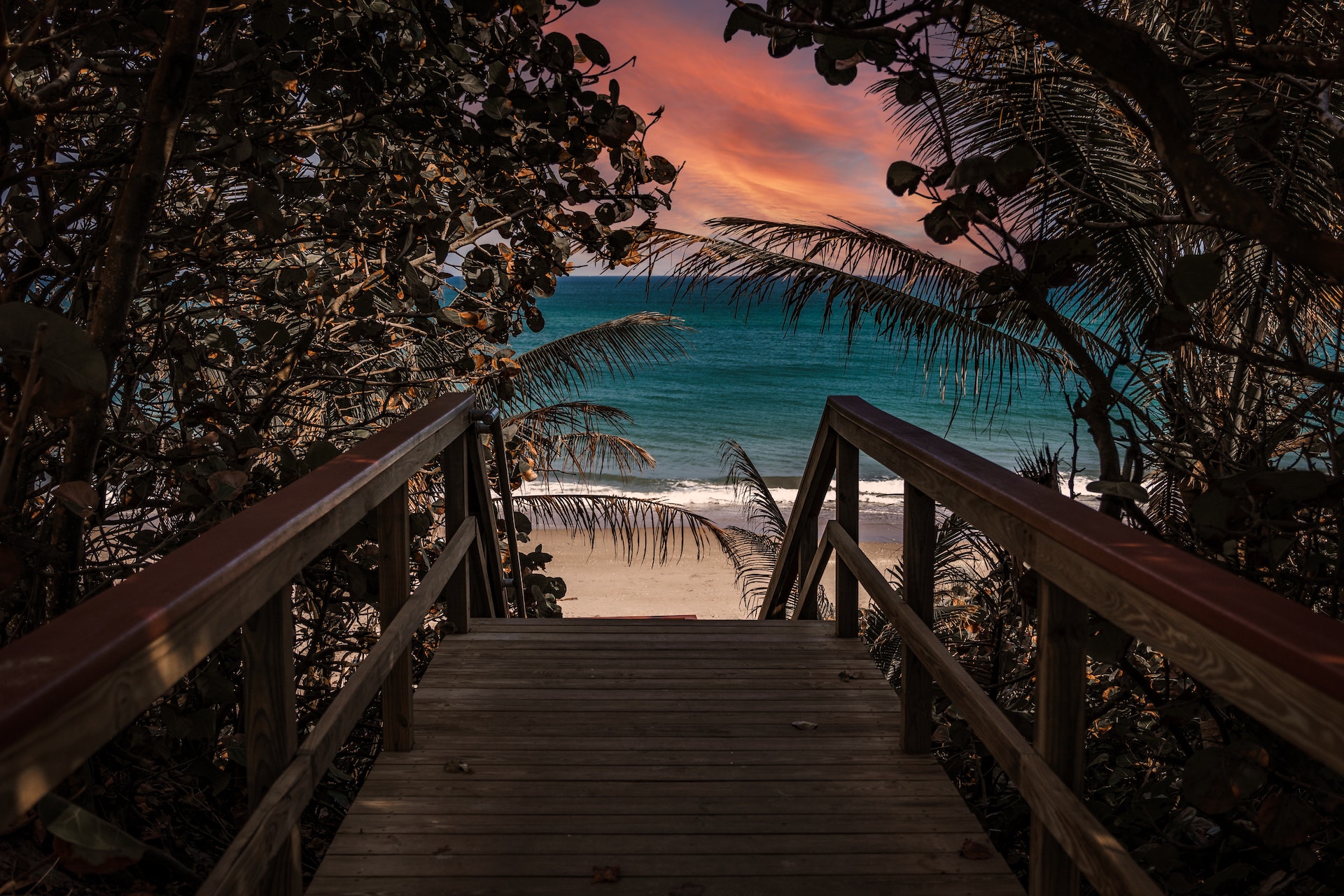 pier overlooking jupiter beach sunrise
