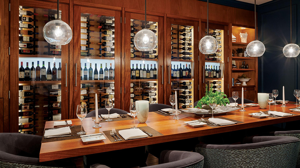 The Glass Room at Salt Kitchen & Bar is a private dining space, displaying the bottles on the lauded wine list.