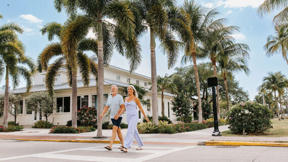 couple crossing the street at the capri inn