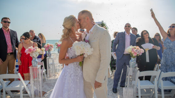 A happy couple during their beach ceremony at Edgewater Beach Hotel.