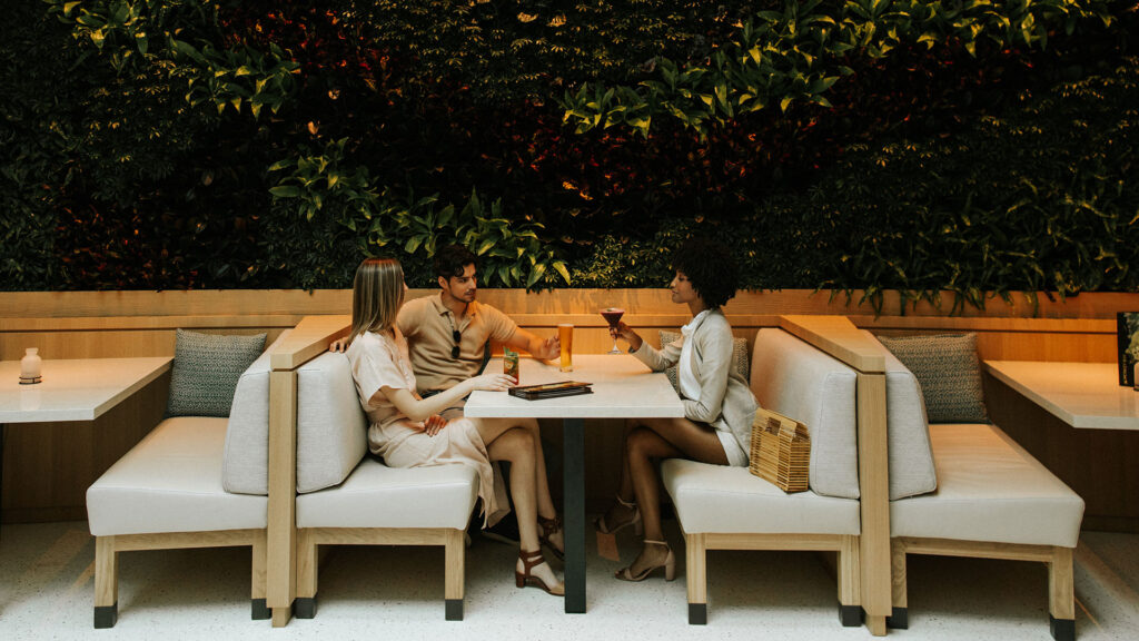 A group of friends sample rum cocktails at Monkey Bar at Opal Grand Resort & Spa.