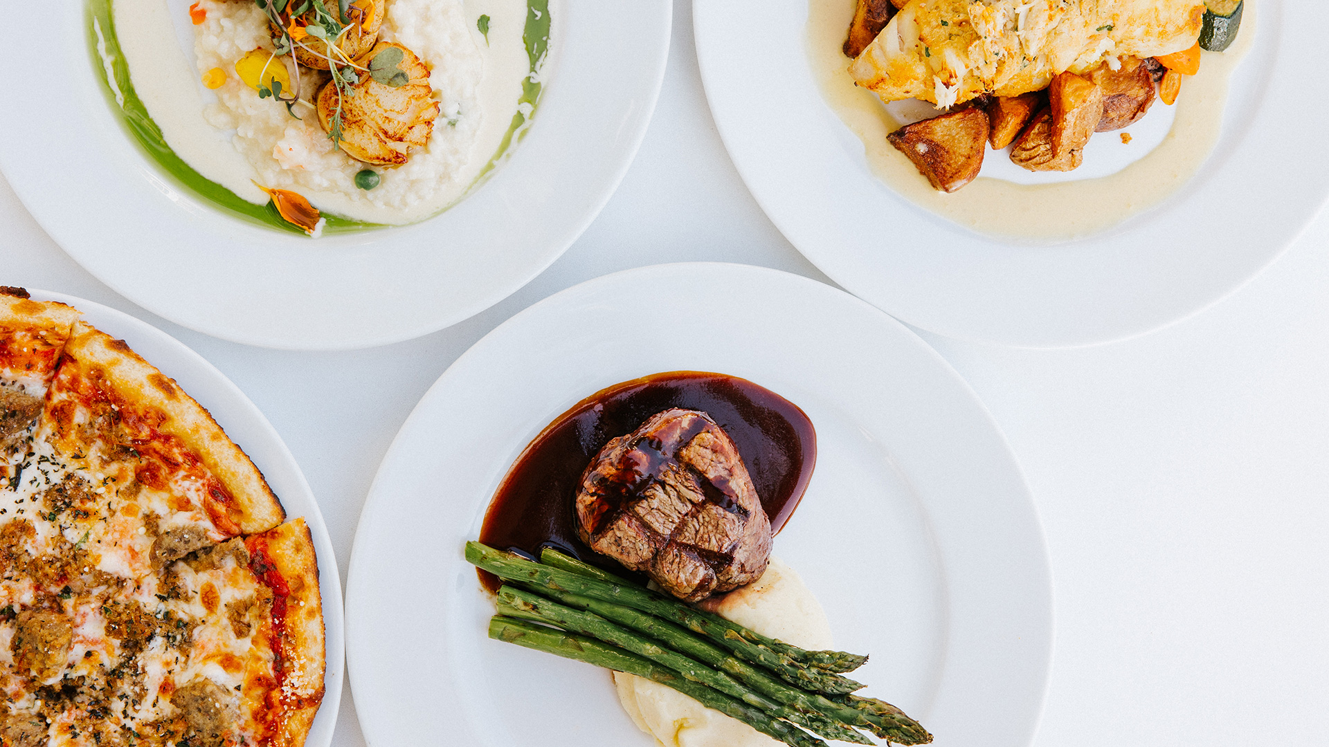 Seafood, steak, and pizza dishes at Drift Kitchen & Bar in Jensen Beach, Florida.