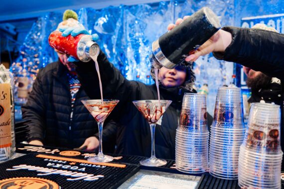 Bartenders make a drink at the ice bar.