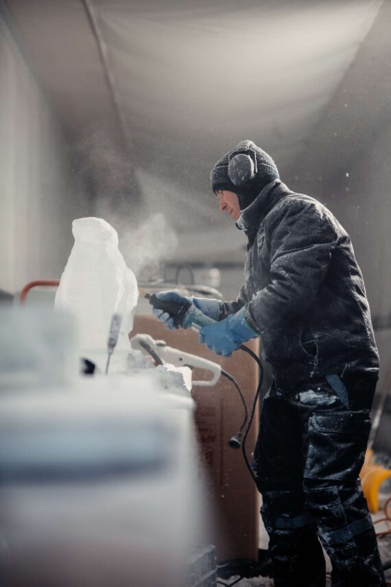 A ice sculptor carves out an piece for the annual Glacier Ice Bar.