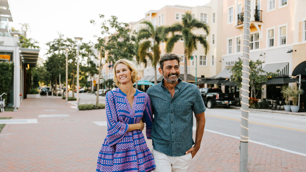 A couple strolls Atlantic Avenue in Delray Beach