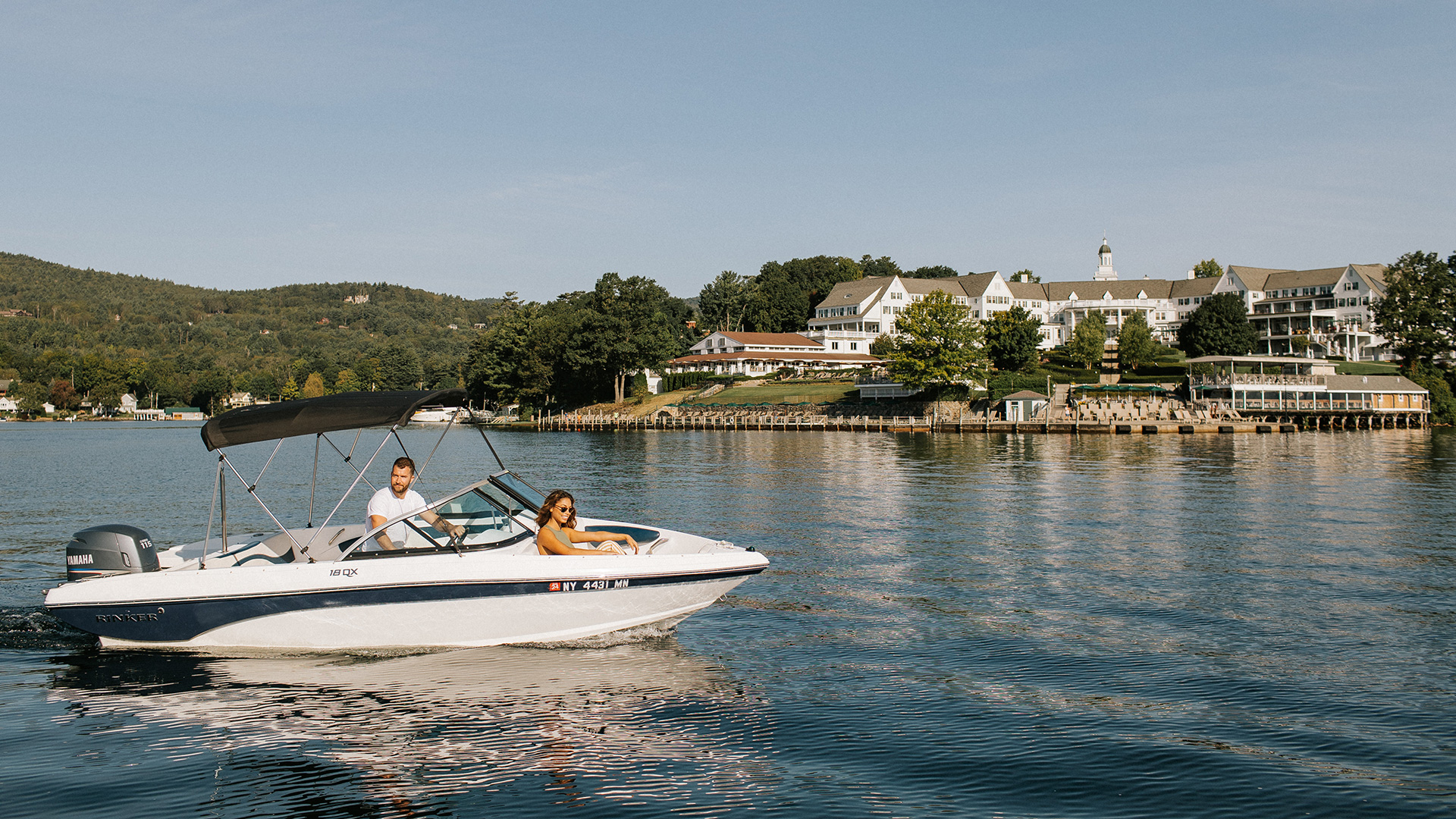 A couple boats on Lake George with The Sagamore in the backdrop.