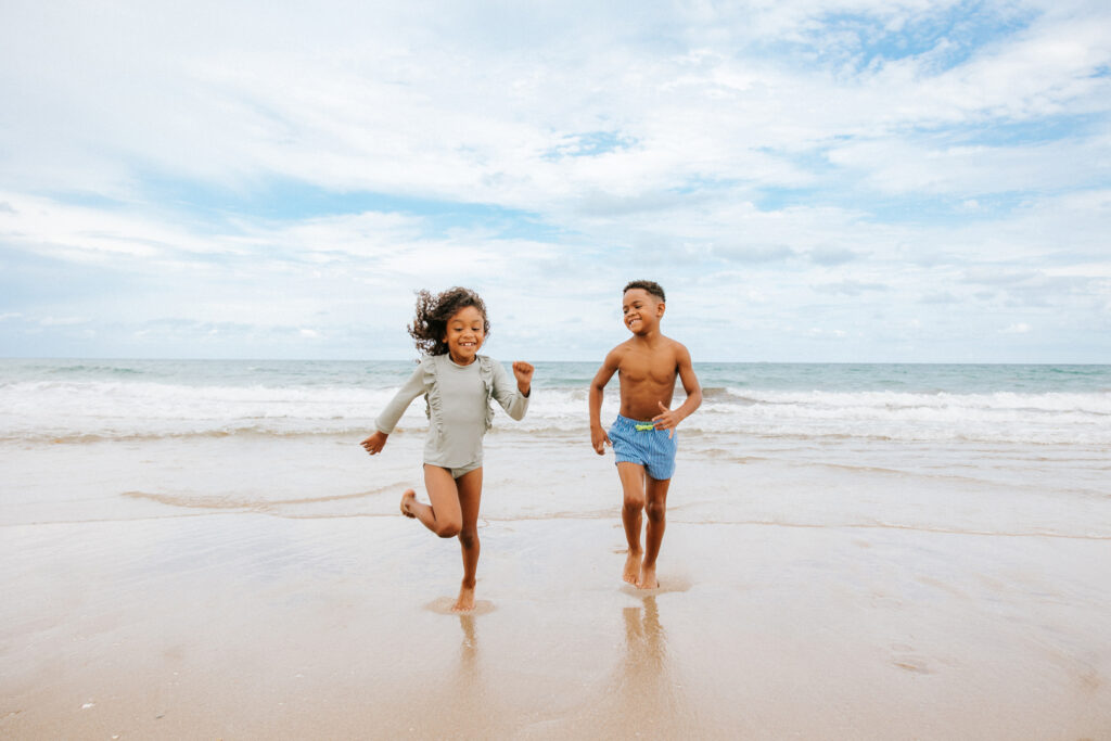 Two kids play in the water at Delray Beach, Florida.