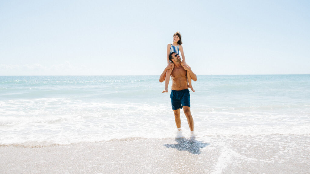 A father and daughter play in the gin-clear waters of Jupiter, Florida.