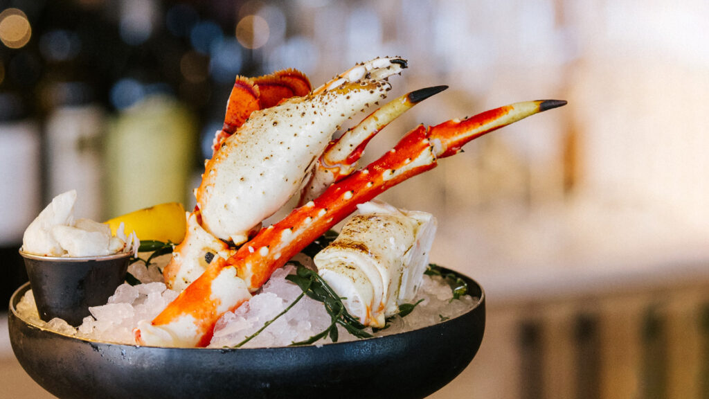 A close-up of a seafood tower featuring stone crab claws, a delicacy, at Delray Sands Resort in Delray Beach, Florida.