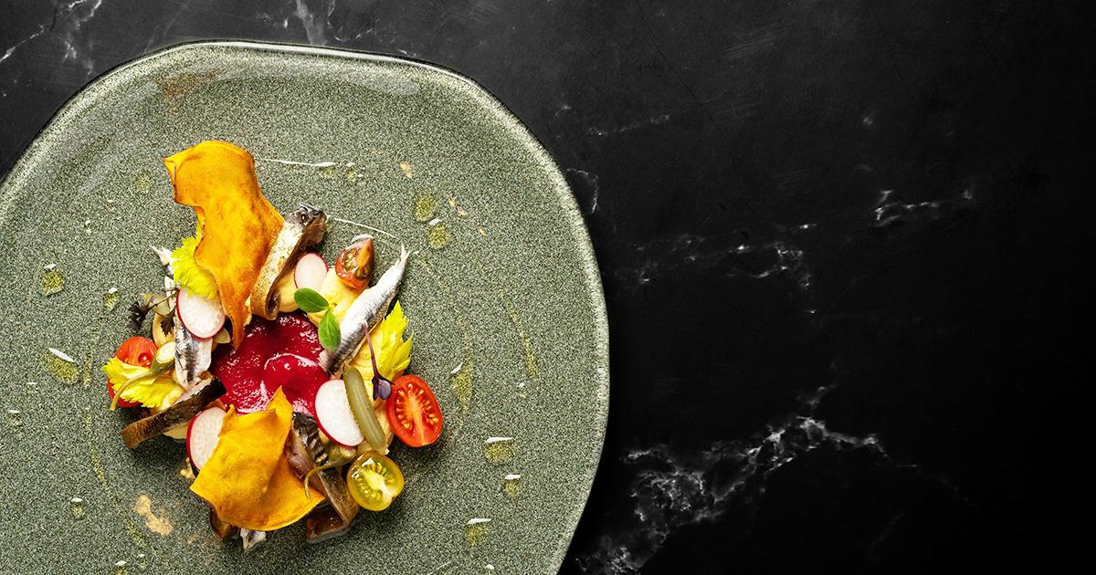 A greek dish featuring fish and vegetables, like what is to be served at Blue Kouzina in Sarasota, Florida.