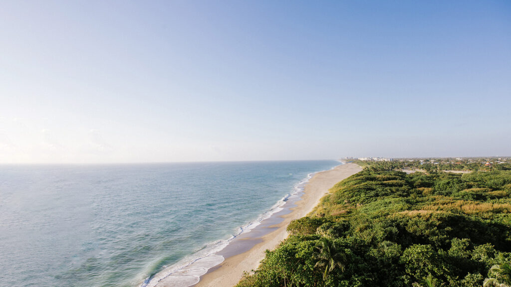 Aerial view of the scenic beach at Jupiter Beach Resort.