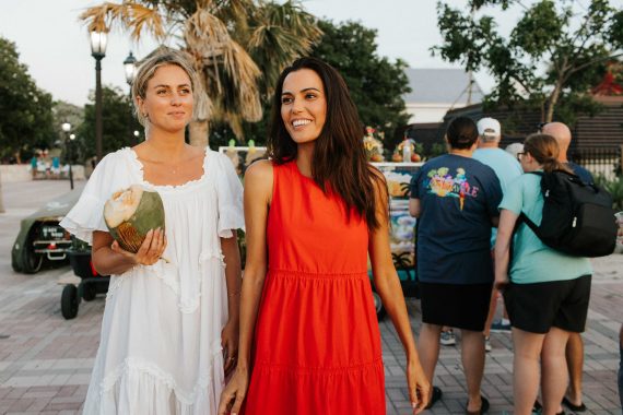 Two women stroll through the streets of Key West.