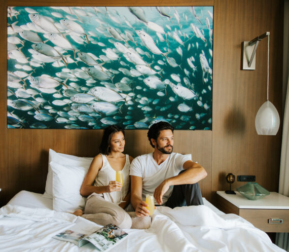 couple stting in bed at opal sands