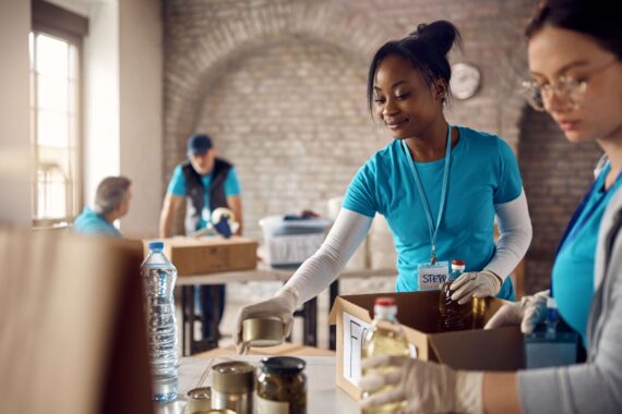 A group organizes boxes of food for a local food bank.