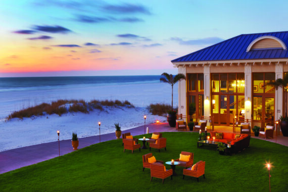 exterior of hotel at night along the beach