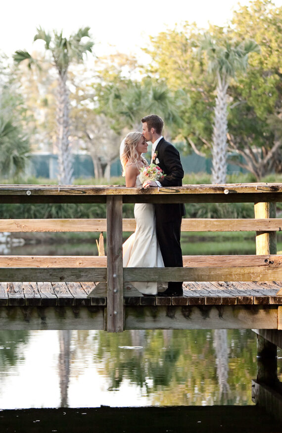 Wedding couple standing on a bridge in Florida