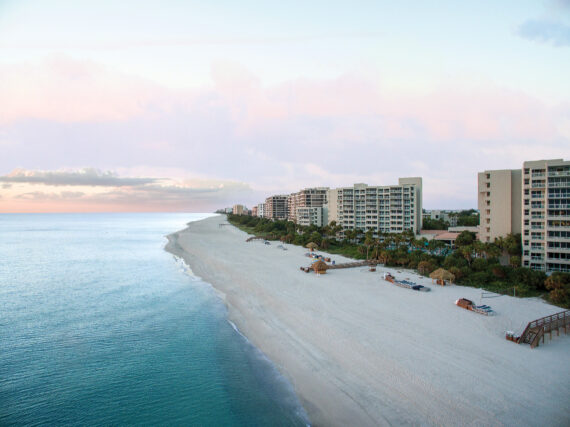 Aerial view of an empty beach on the coastline at sunrise