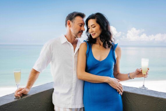 couple standing on the oceanfront balcony at the resort at longboat key club