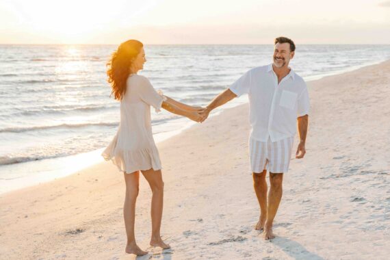 couple walking on the beach at sunset