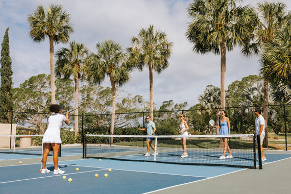 A group partakes in an pickleball clinic.