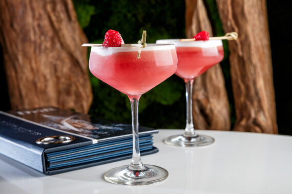two pink cocktails on a table