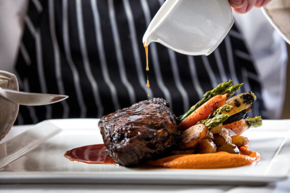 Steak with roasted potatoes, carrots, and asparagus.