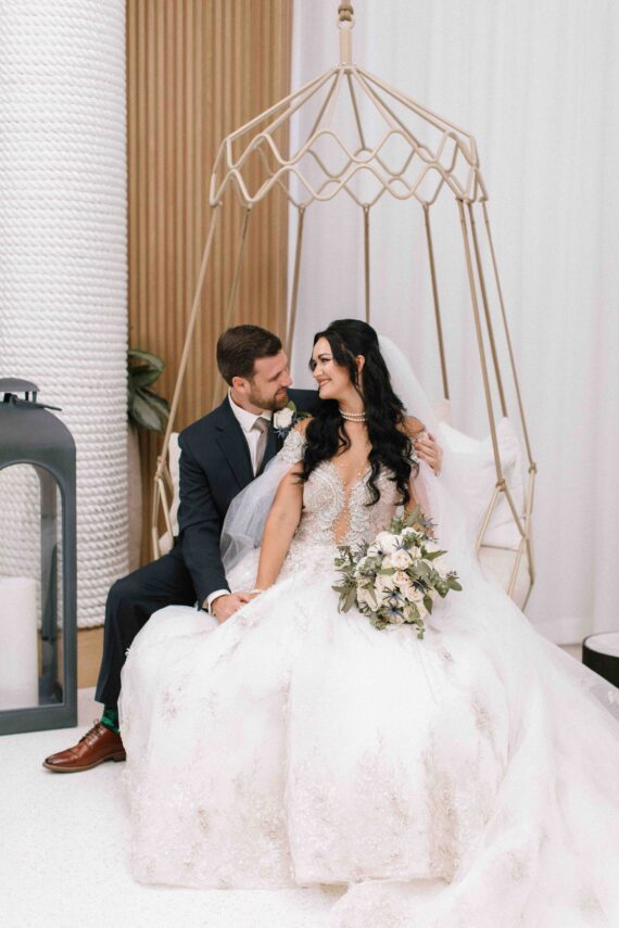 newly married couple gazing at each other in the lobby of opal grand