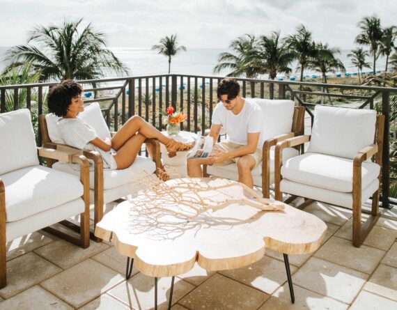 couple lounging on a balcony of opal grand