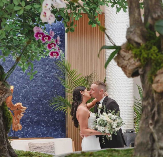 wedding couple kissing in opal grand lobby