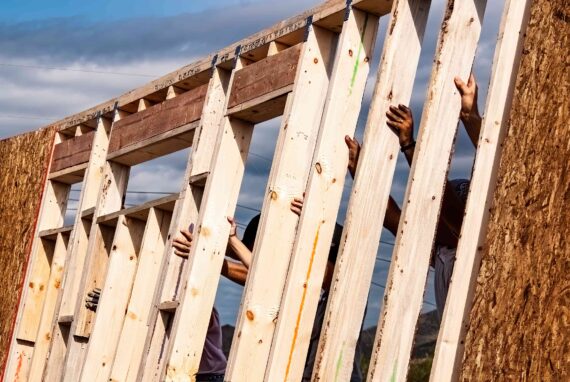 A group assembles a structure for Habitat for Humanity.