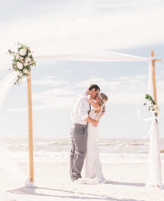 couple kissing at the alter on the beach