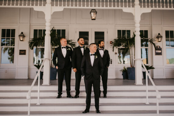 groom and groomsmen standing on belleview steps