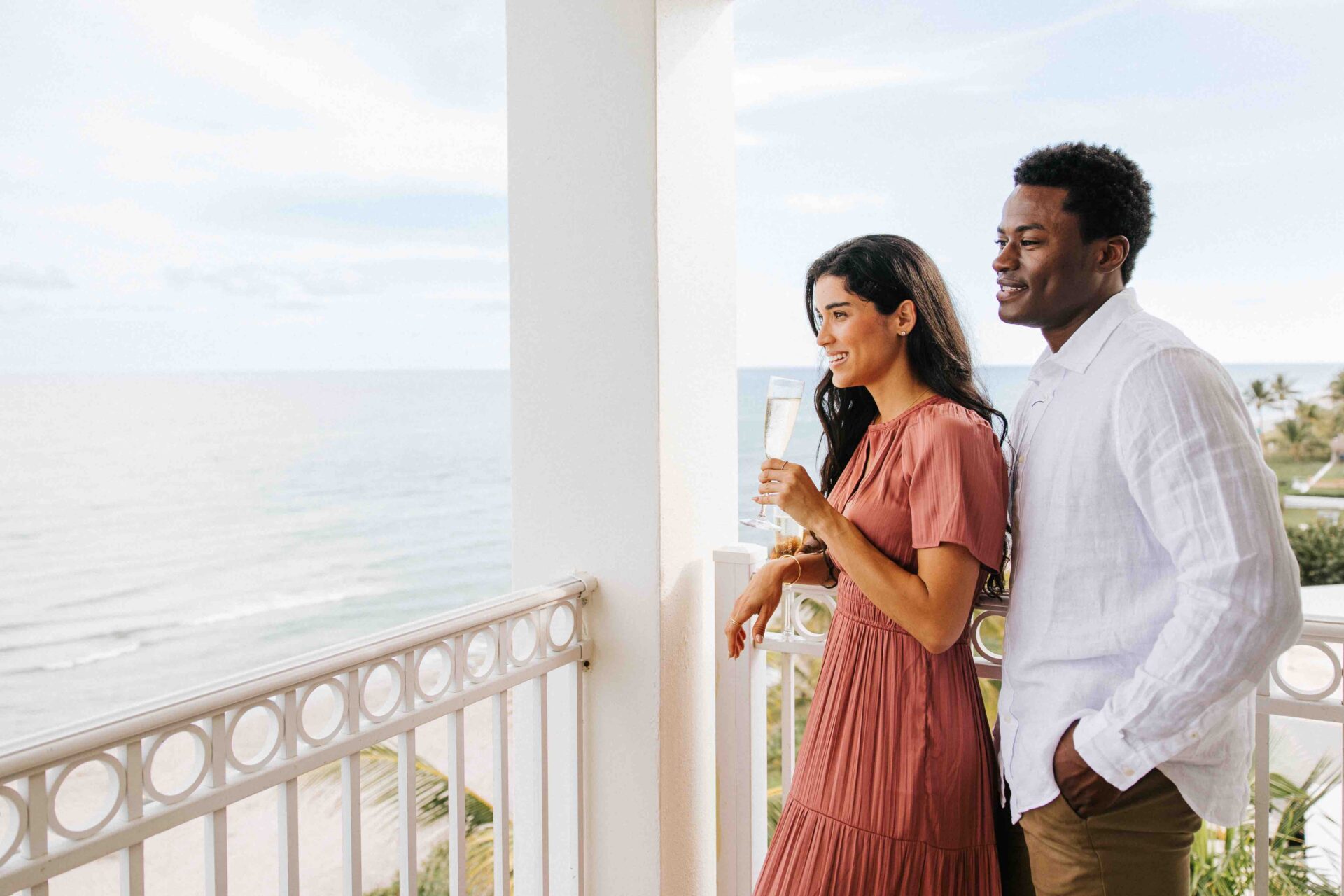 Couple on the balcony of Delray Sands Resort overlooking the ocean.