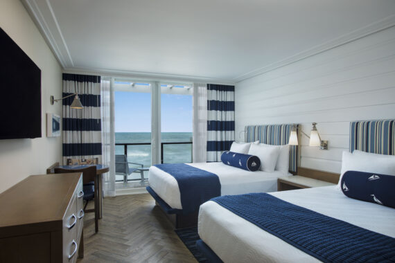 guest room with two beds overlooking the ocean