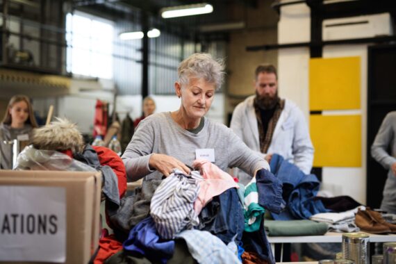 A woman organizes clothing at a Salvation Army Store.
