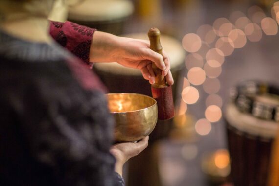 A meditative expert uses a singing bowl.