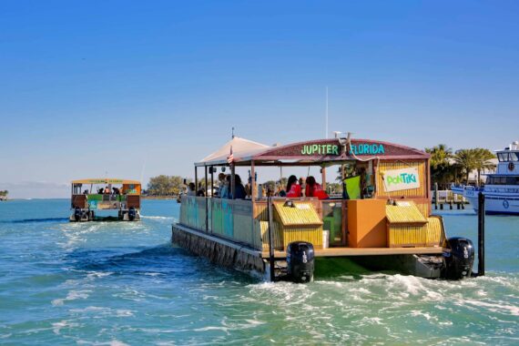 A PonTiki boat cruises along the waters surrounding Jupiter.